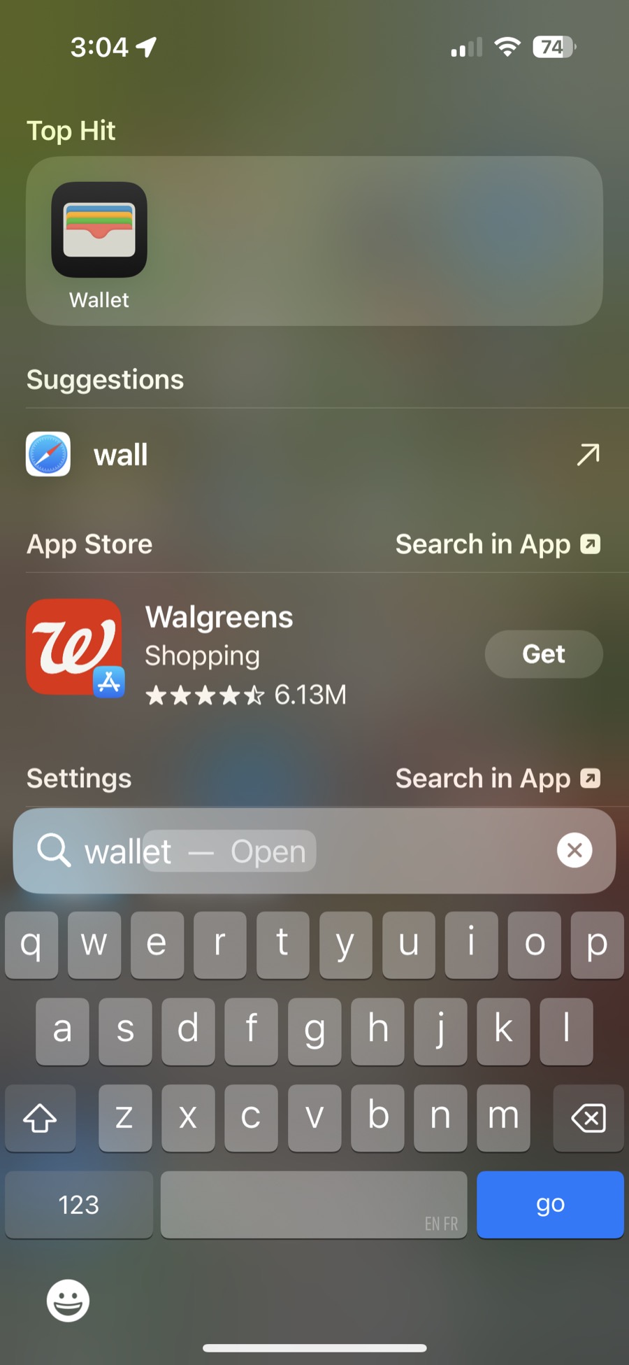 iPhone search showing the Wallet app as the top hit.